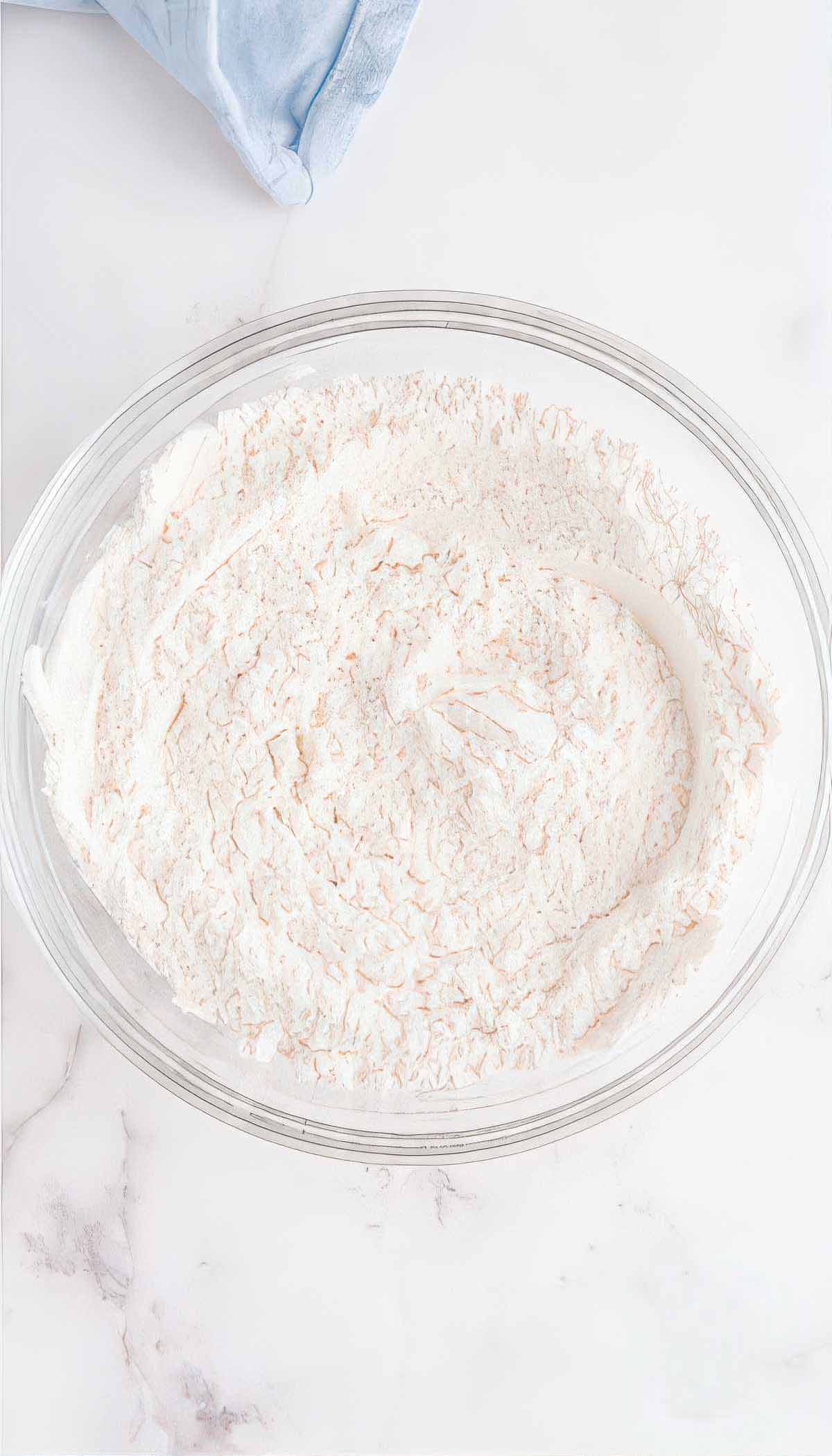 Flour, baking powder, and salt mixed together for blueberry breakfast cake batter.