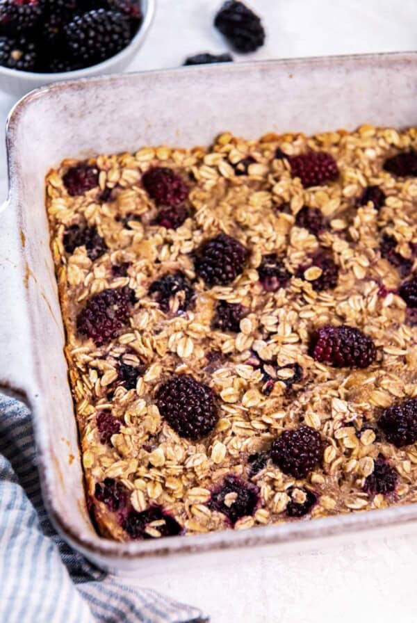 Freshly baked blackberry baked oatmeal in a ceramic baking dish