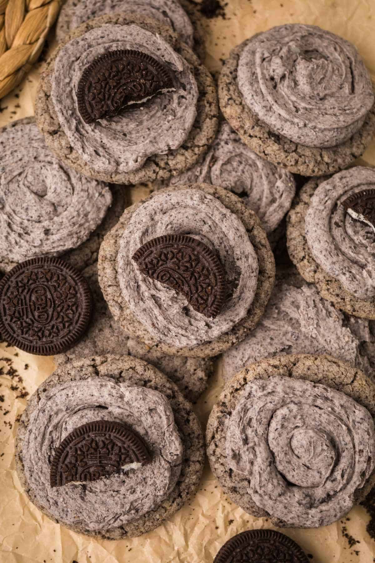 Overhead view of Oreo Milkshake Cookies with cookies-and-cream frosting and Oreo cookie halves.