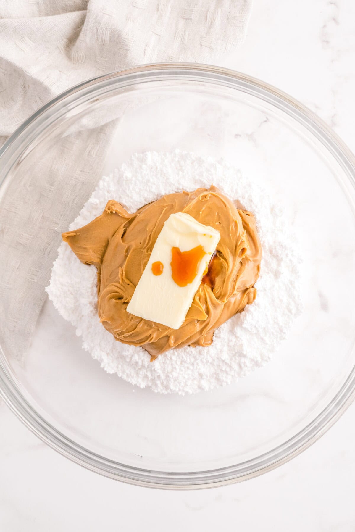 Peanut butter filling mixture with butter and powdered sugar in a mixing bowl