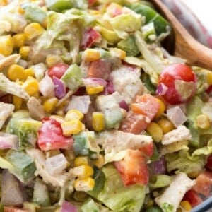 Close up of creamy chicken fajita chopped salad with avocado, corn, tomatoes and shredded chicken