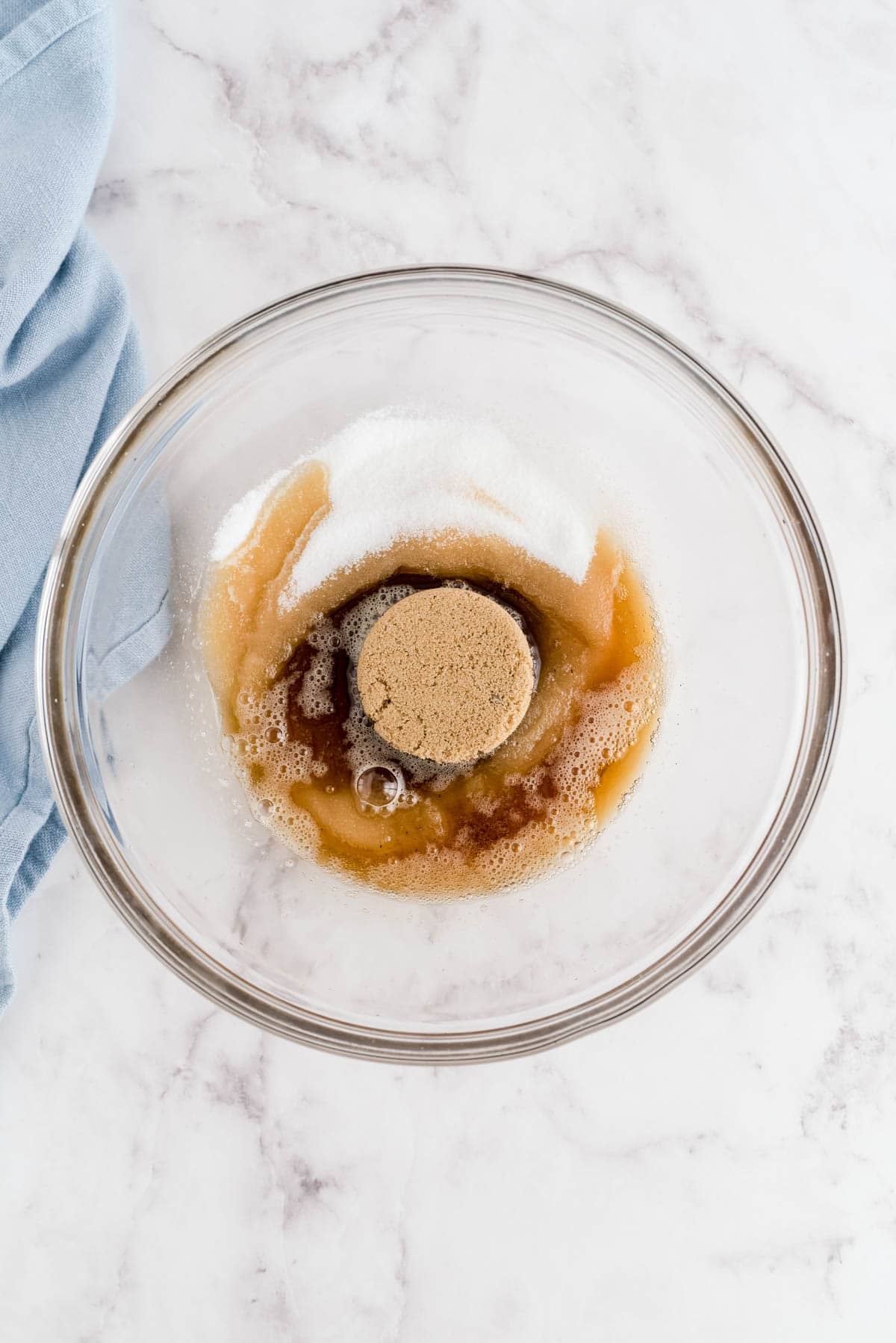 Brown butter mixed with sugar, egg and vanilla in a bowl for snickerdoodle cookie dough