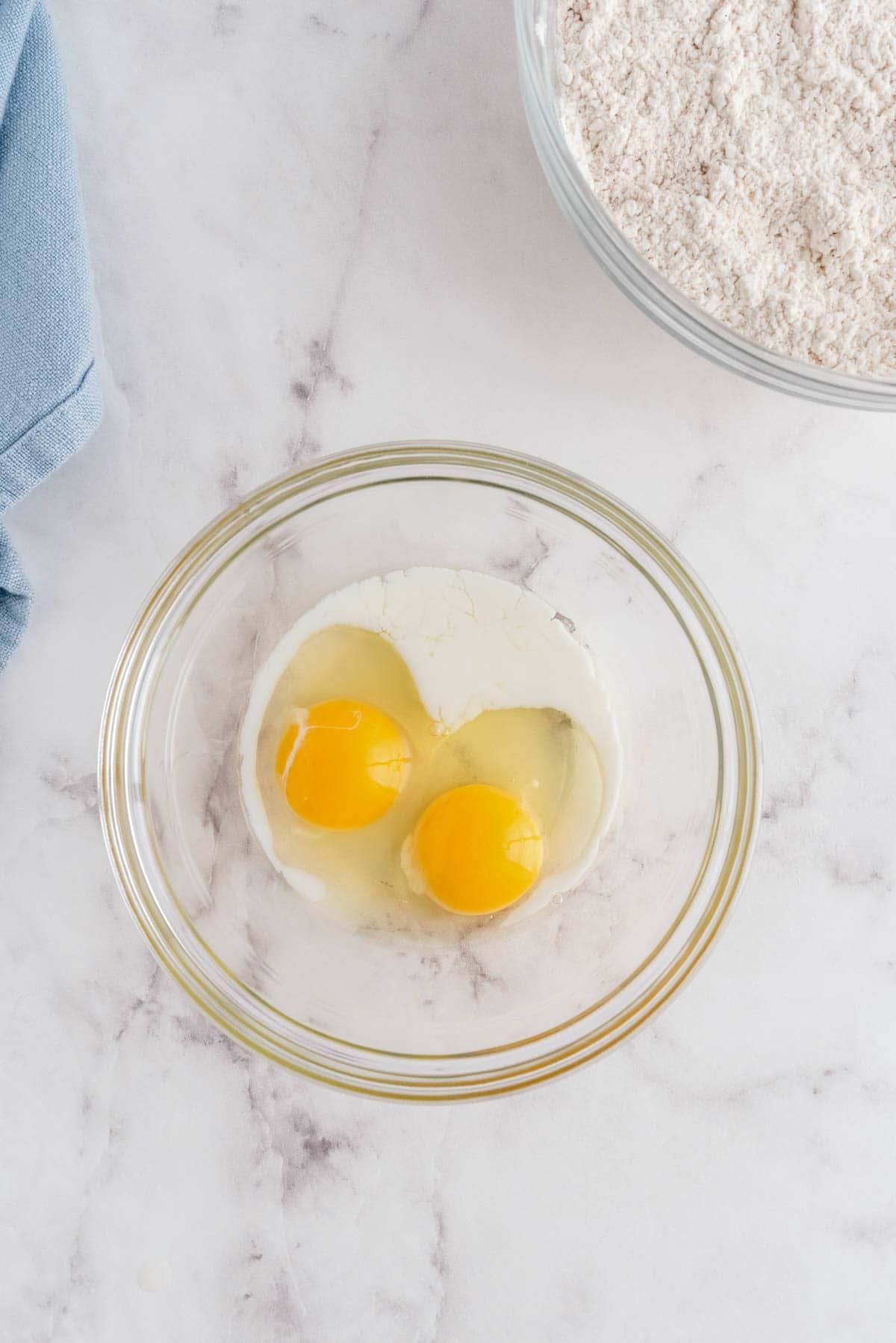 Two eggs in a bowl with milk ready to mix for brown butter snickerdoodle cookie dough