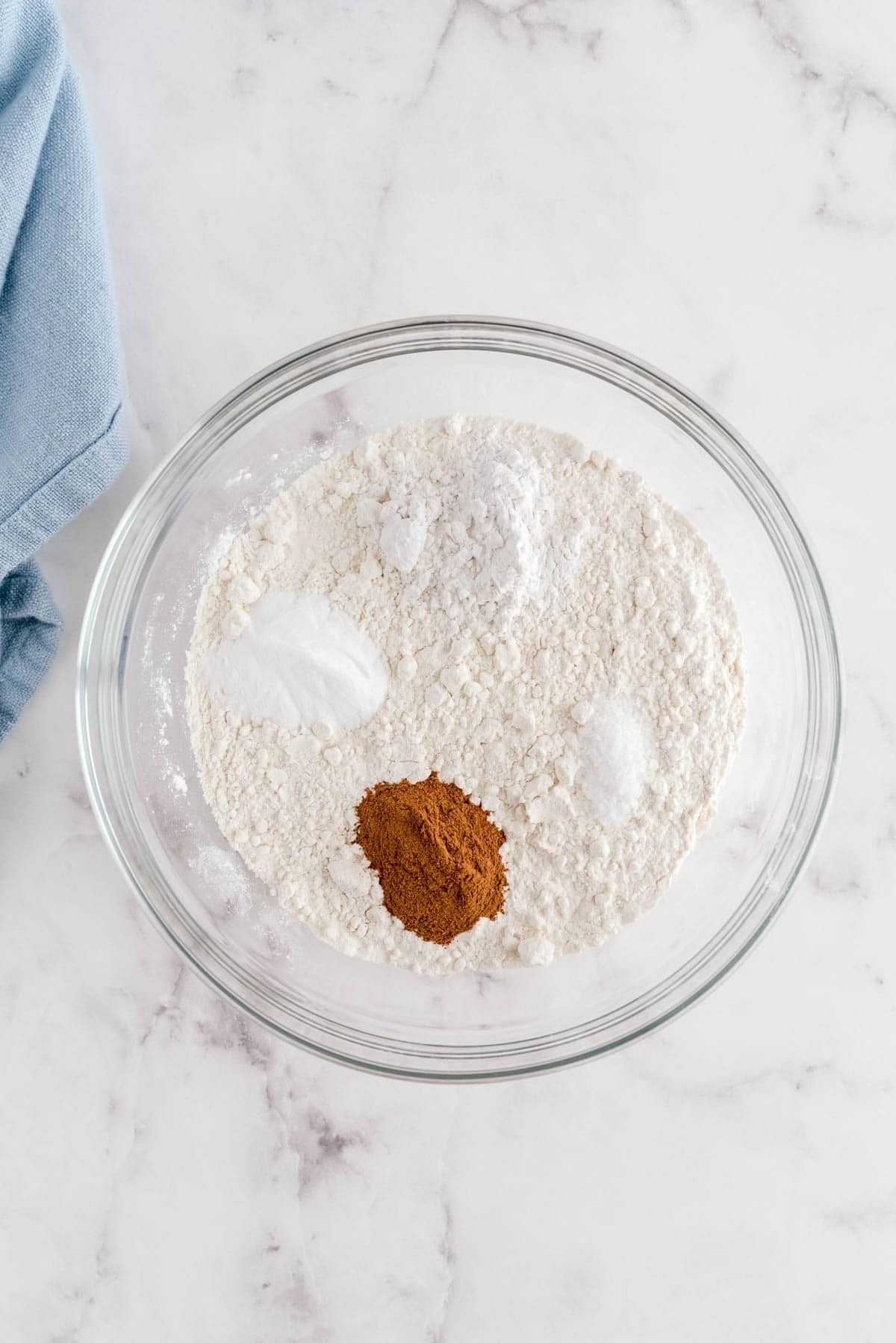 Flour, baking soda, cream of tartar and cinnamon in a bowl for brown butter snickerdoodle cookies
