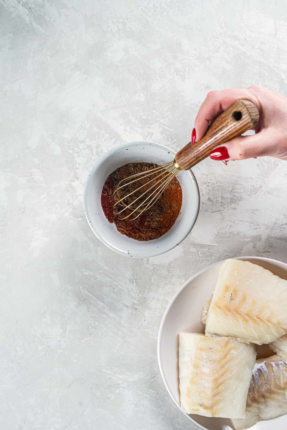 Mixing blackened seasoning spices in a bowl for cod tacos