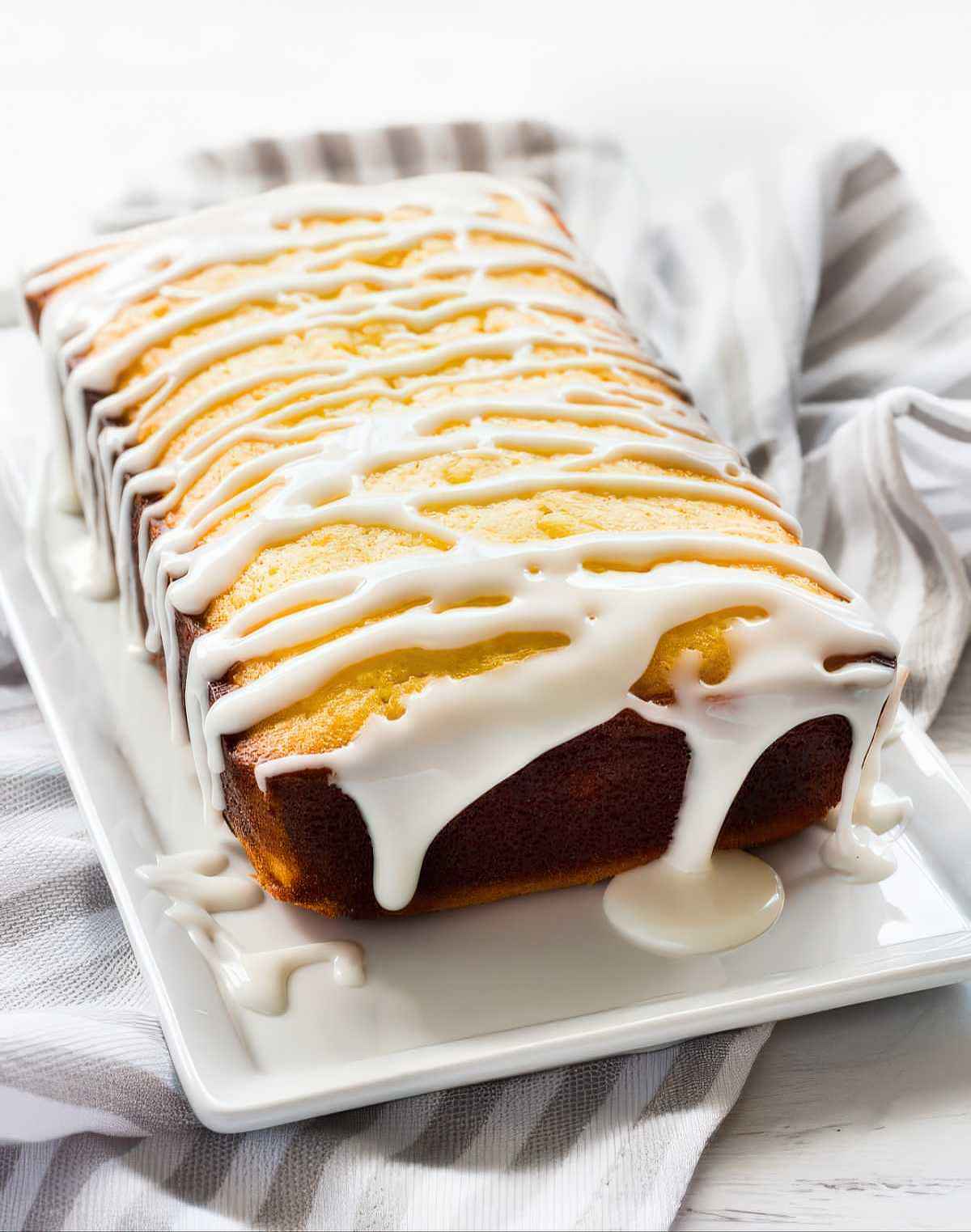 lemon pound cake loaf with thick lemon glaze drizzled on top ready to serve