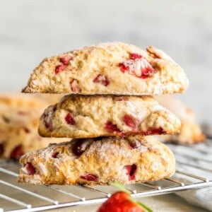 Stack of homemade strawberry scones with fresh strawberries and a lightly golden crust
