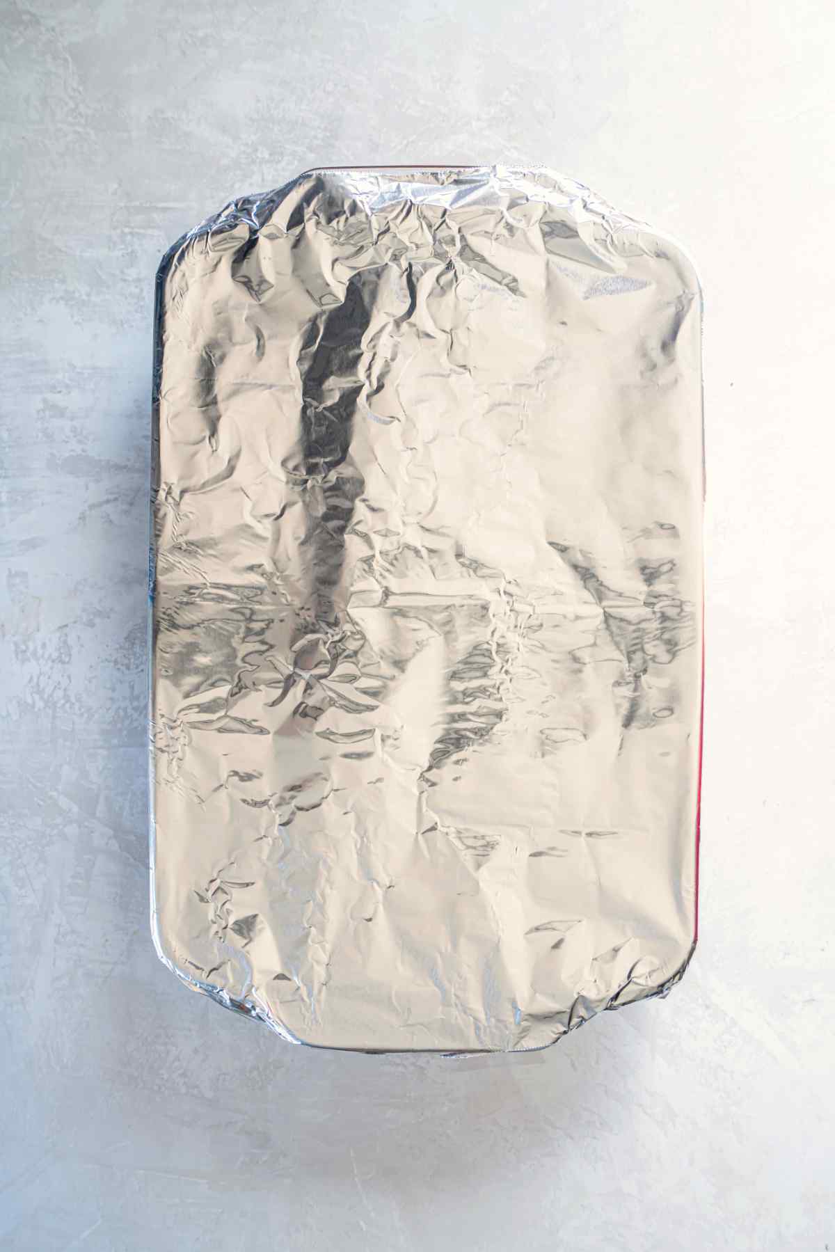 Baking dish of stuffed shells covered with foil before going into the oven