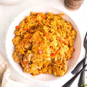 Creamy Cajun chicken orzo served in a bowl with tender chicken, red bell peppers, and a rich Cajun-seasoned sauce.