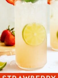 Strawberry mojito garnished with fresh mint and sliced strawberries served over ice.