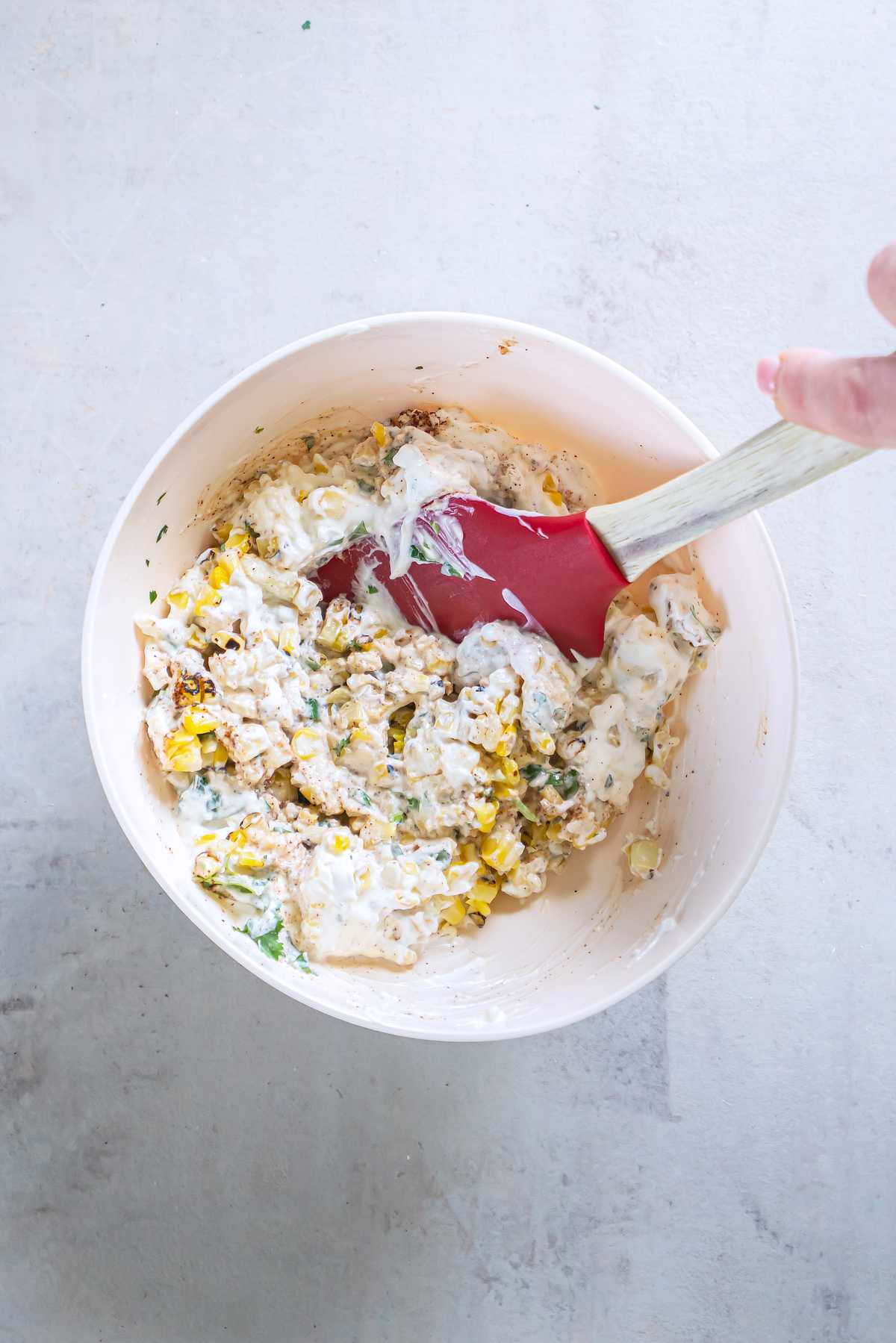 Charred corn kernels mixed with sour cream, mayonnaise, Cotija, cilantro, scallions and chili powder.