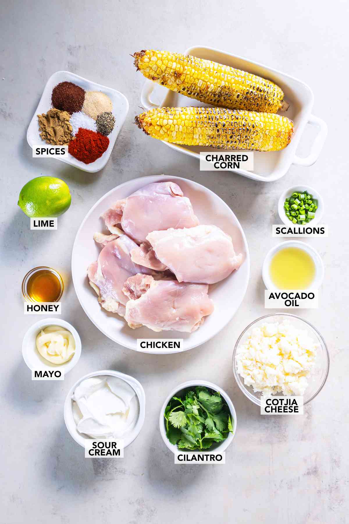 Chicken thighs, charred corn, lime, honey, avocado oil, spices, scallions, mayonnaise, sour cream, Cotija cheese and cilantro.
