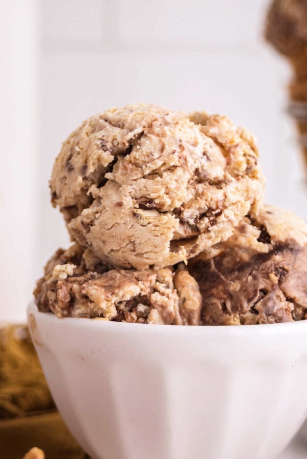 Close up of Nutty Buddy ice cream in a bowl with peanut butter ice cream, chocolate swirls and pieces of wafer bars.