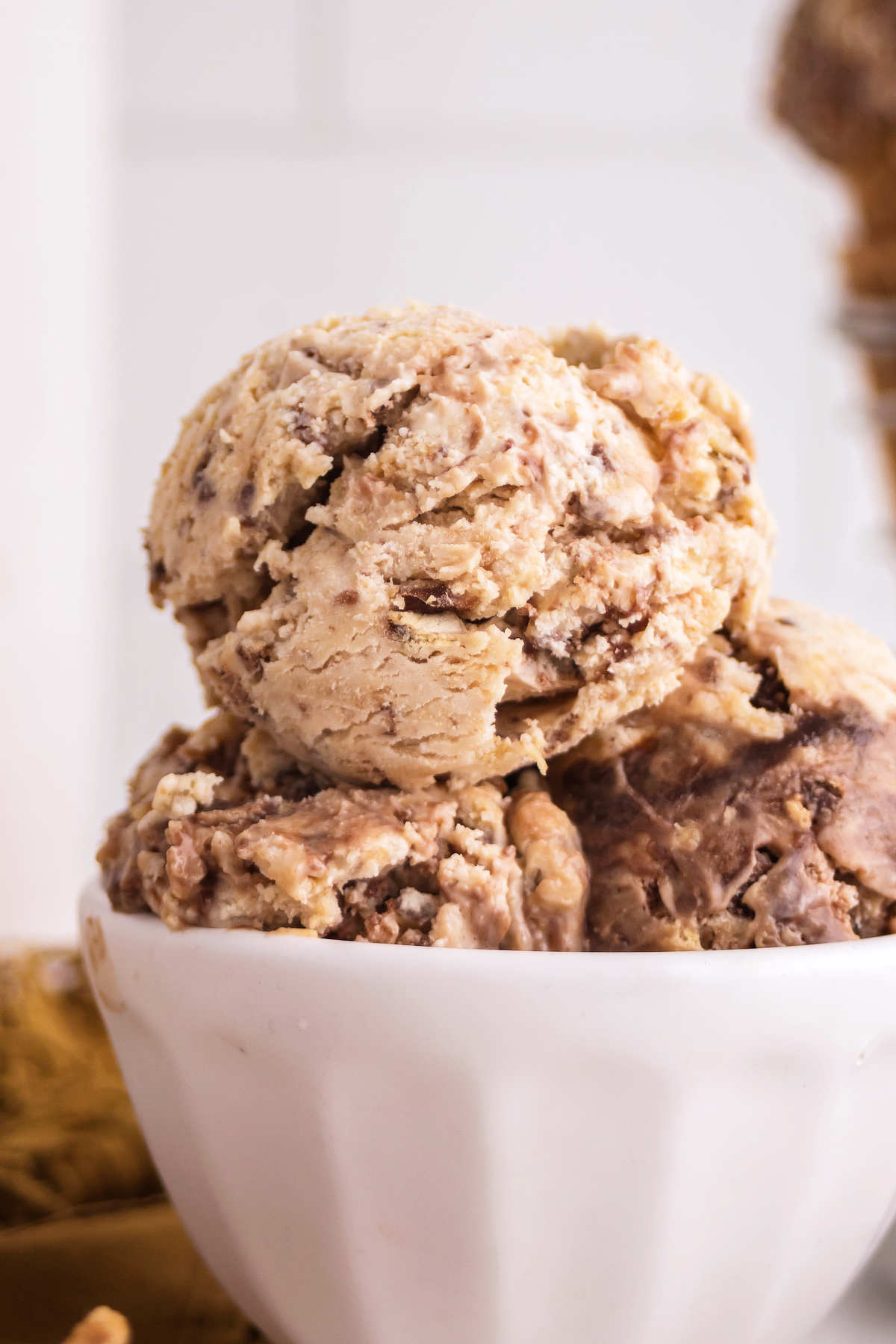 Close up of Nutty Buddy ice cream in a bowl with peanut butter ice cream, chocolate swirls and pieces of wafer bars.